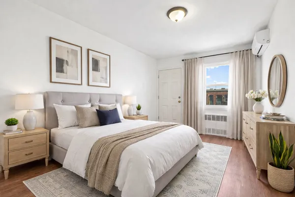 a bedroom with a balcony a bed and a potted plant