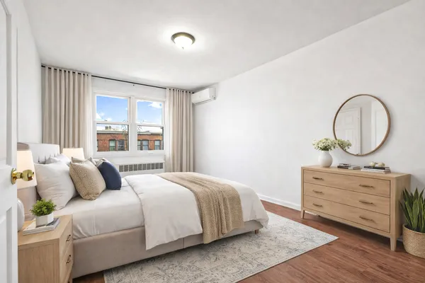 a bedroom with a bed and a dresser