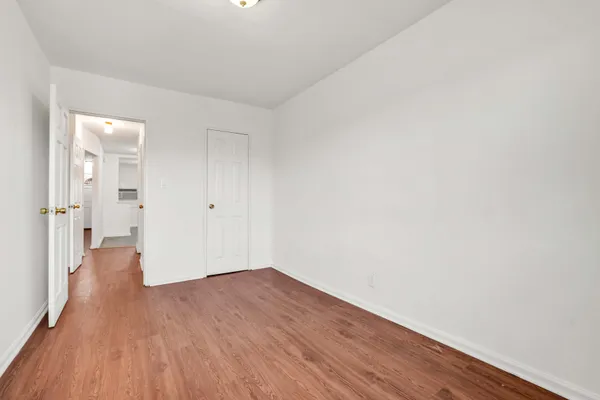 a view of a room with wooden floor