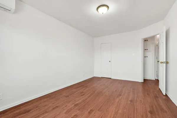an empty room with wooden floor