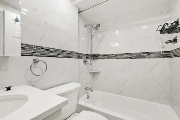 a bathroom with a tub sink and mirror