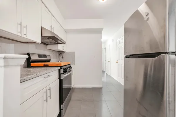 a kitchen with stainless steel appliances a refrigerator and a stove