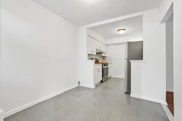 a view of a kitchen with refrigerator and a sink