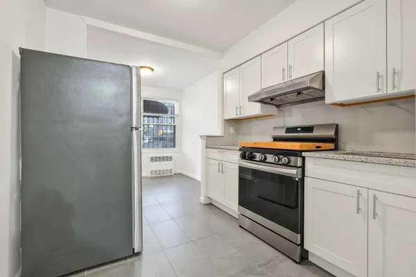 a kitchen with stainless steel appliances granite countertop a stove and a refrigerator