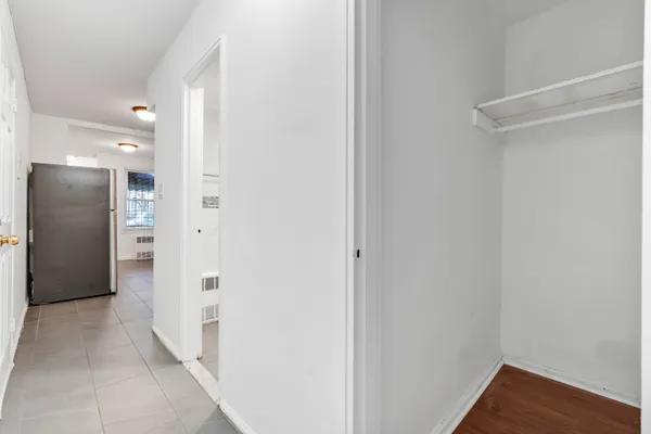 a view of a hallway with wooden floor