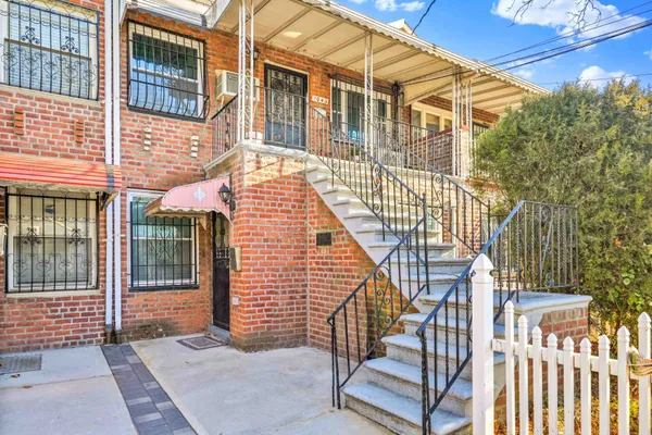a view of a house with a wooden deck