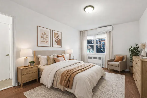 a bedroom with bed couch and window