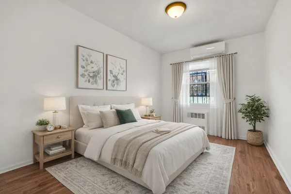 a bedroom with a bed and a potted plant