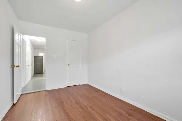 an empty room with wooden floor