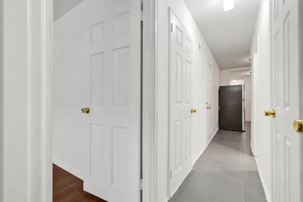 a view of a hallway with wooden floor