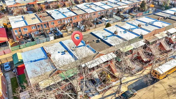 an aerial view of residential houses with city view