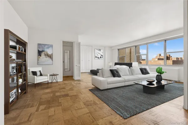 a living room with furniture a rug and a window