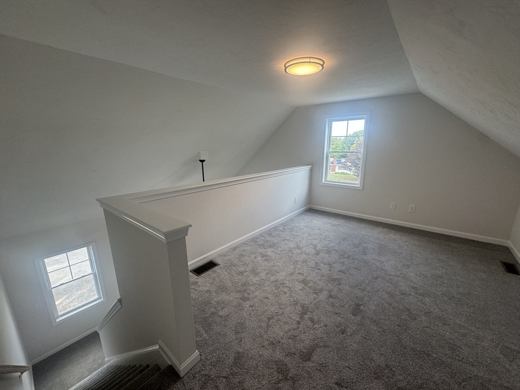 15 Ambrose Way, Unit 15 Shirley, MA 01464 - Photo 19 of 21 a view of an empty room with windows and fireplace
