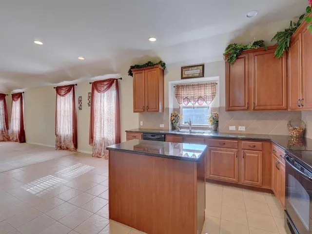 a kitchen with stainless steel appliances granite countertop a sink and a granite counter tops
