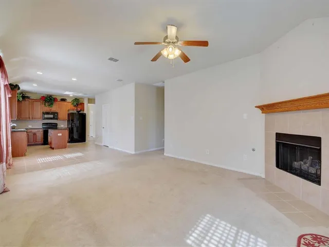 a view of an empty room with closet and a fireplace