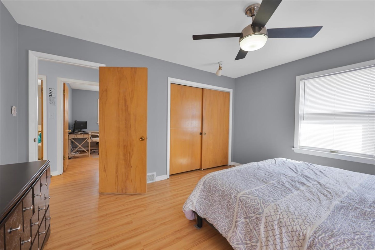 3323 Dell Oak Drive Decatur, IL 62526 - Photo 20 of 32 a bedroom with a bed and a chandelier