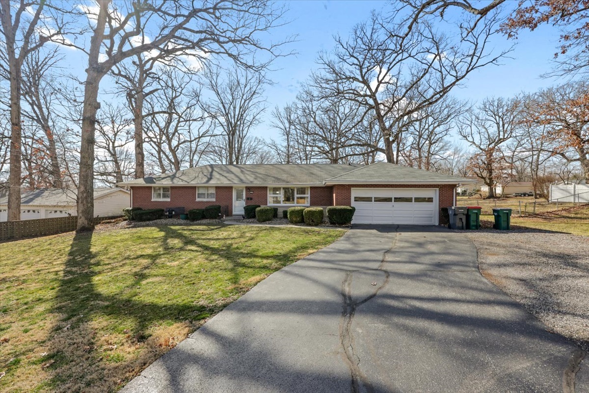 3323 Dell Oak Drive Decatur, IL 62526 - Photo 2 of 32 a front view of a building with a yard and large trees