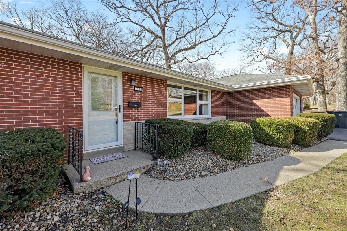 3323 Dell Oak Drive Decatur, IL 62526 - Photo 3 of 32 a view of a house with brick walls and potted plants