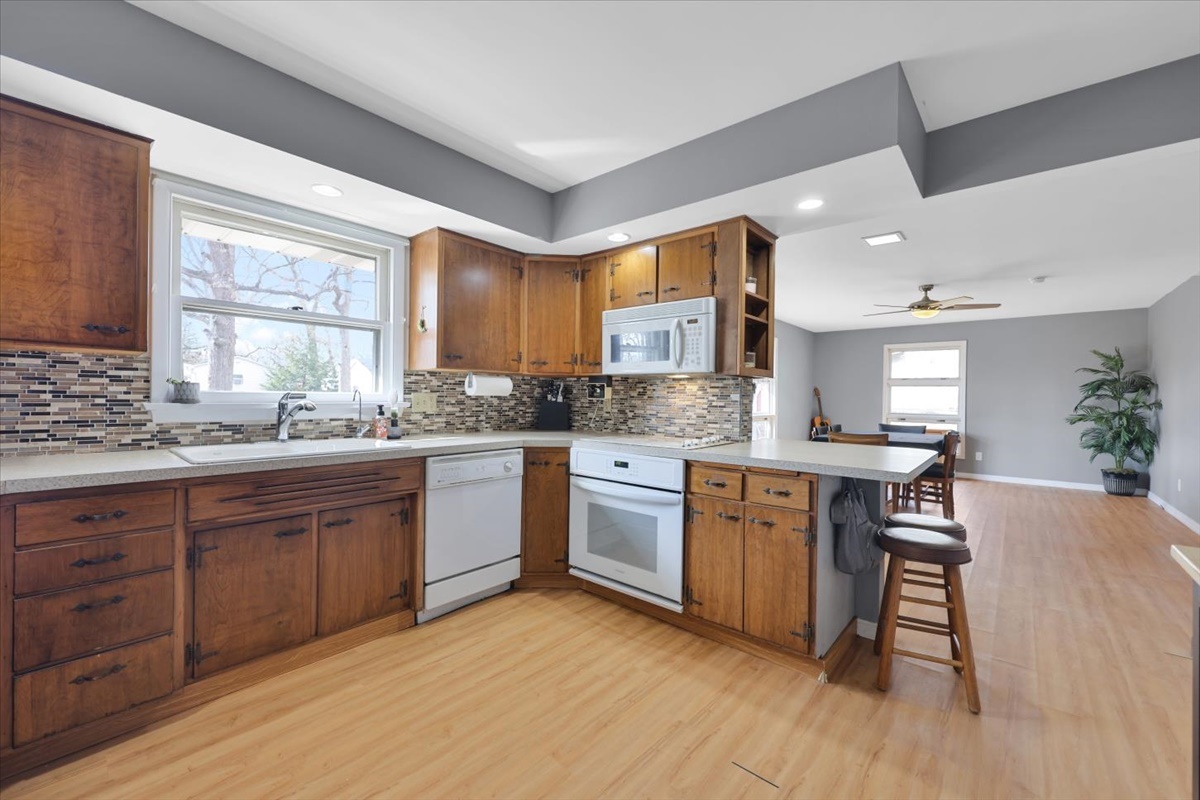 3323 Dell Oak Drive Decatur, IL 62526 - Photo 10 of 32 a kitchen with wooden floors and white cabinets