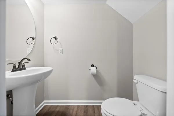 a bathroom with a sink a toilet and mirror