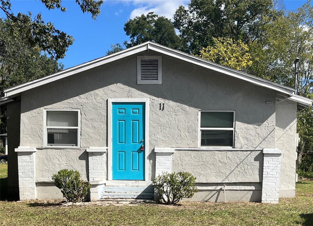 a front view of a house with plants