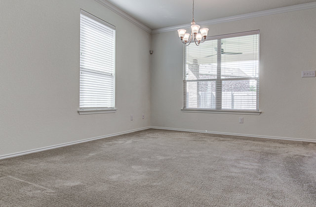 1237 Volente Lane Leander, TX 78641 - Photo 3 of 22 A classic chandelier illuminates this flexible living area, adaptable to various layouts and functions.