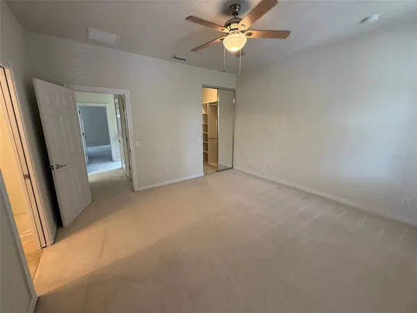 a view of walk in closet with empty racks