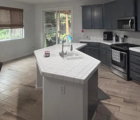 a view of an empty room with a fireplace and a window
