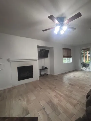 a bathroom with a sink a toilet a window and shower