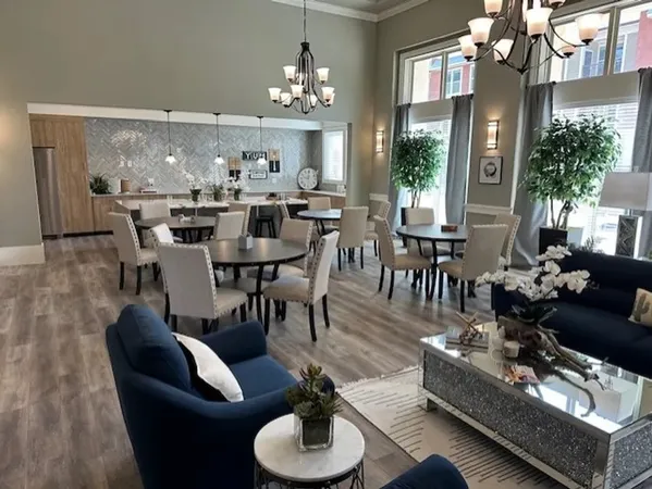 a view of a dining room with furniture a chandelier and wooden floor