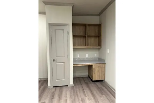 a room with a wooden floor and closet