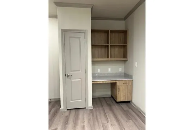 a room with a wooden floor and closet