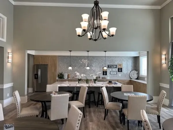 a view of a dining room with furniture wooden floor and chandelier