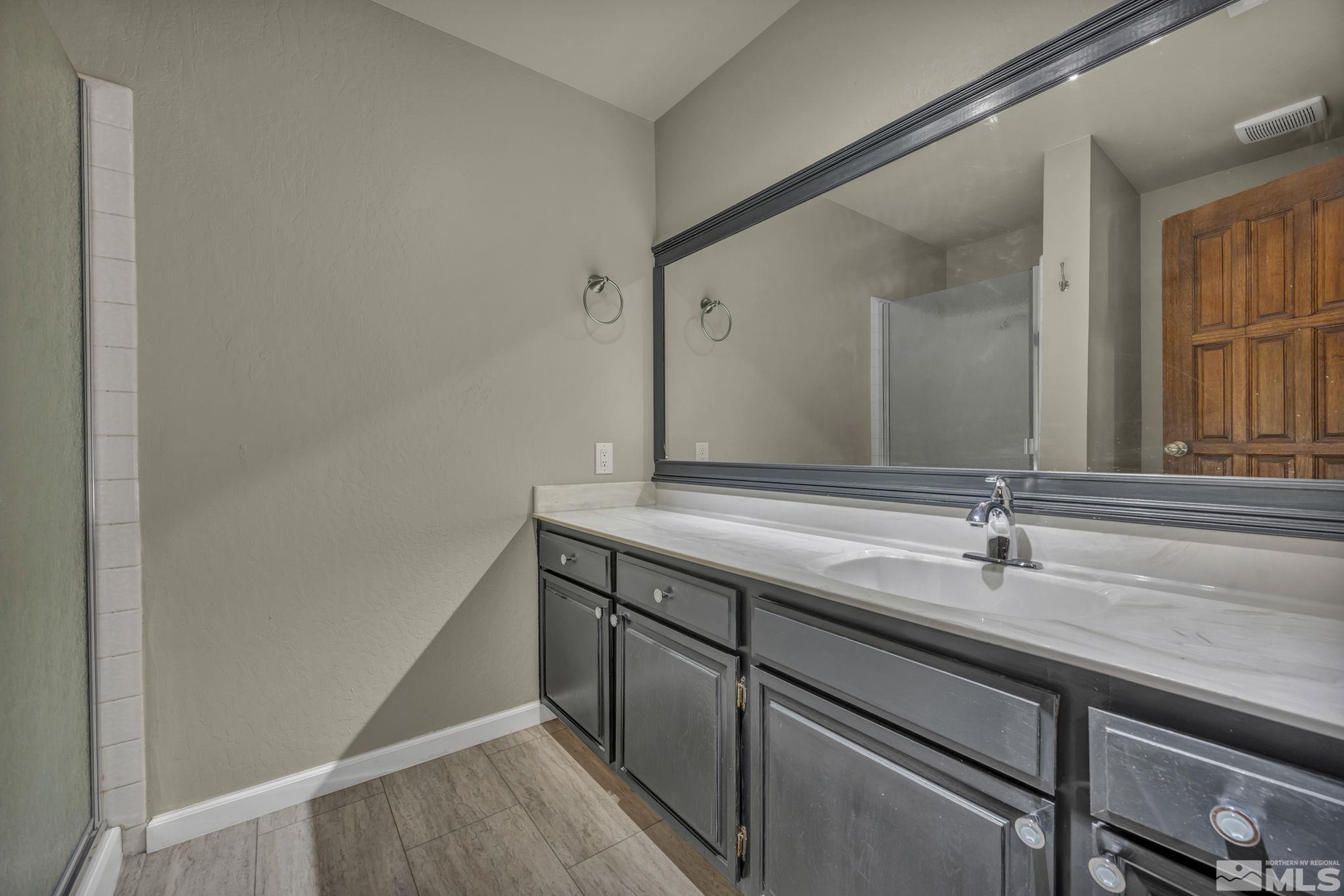 4311 Clyde Court Reno, NV 89509 - Photo 18 of 40 a bathroom with a sink and a mirror