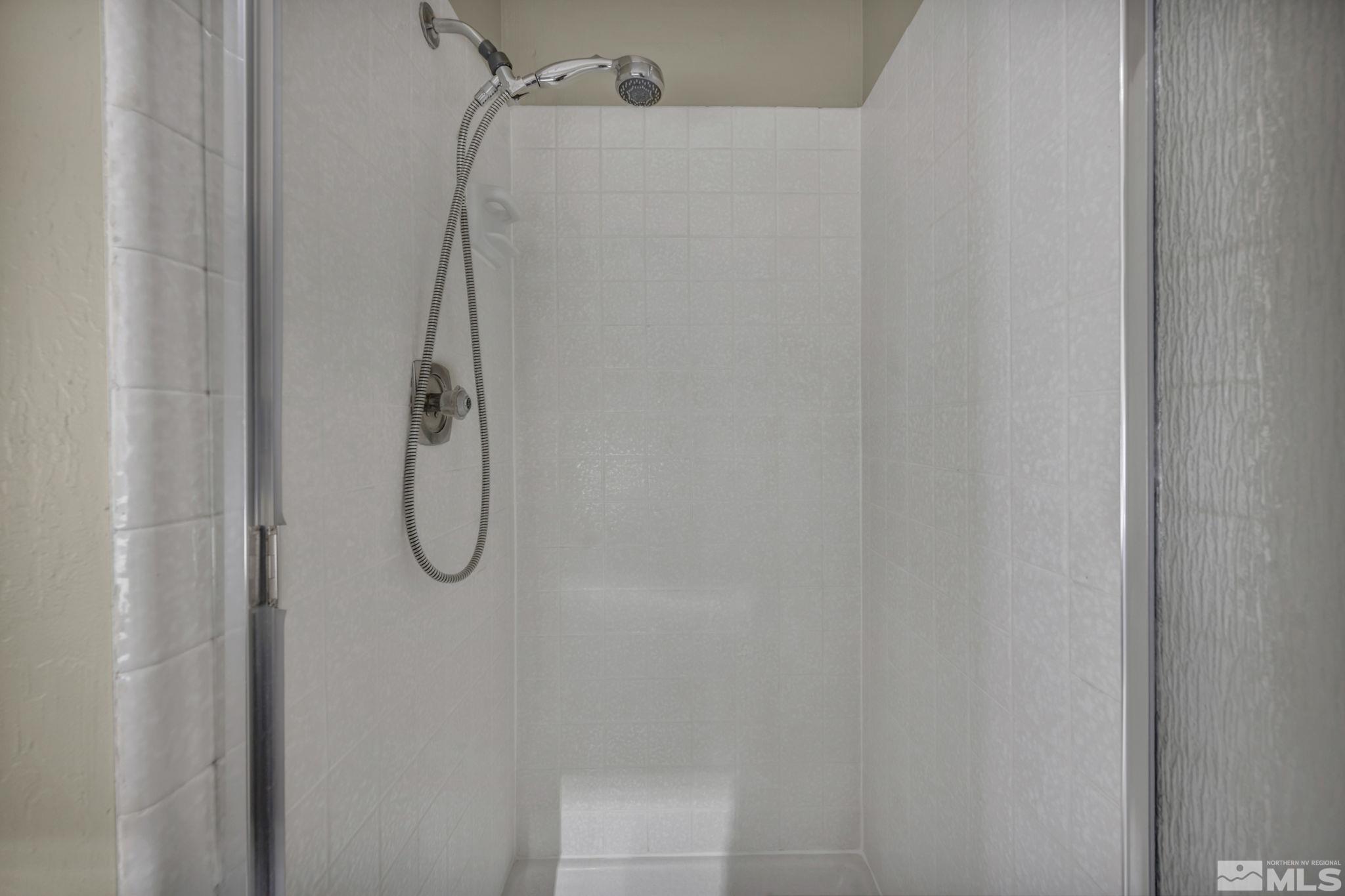 4311 Clyde Court Reno, NV 89509 - Photo 20 of 40 a bathroom with a glass shower door