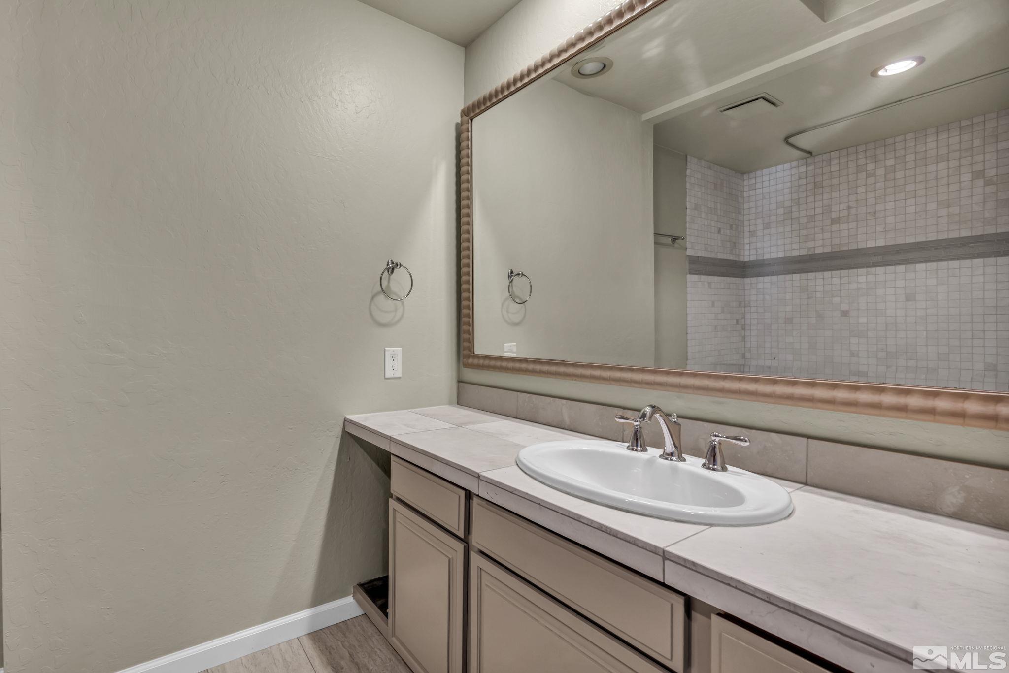 4311 Clyde Court Reno, NV 89509 - Photo 25 of 40 a bathroom with a sink and a mirror