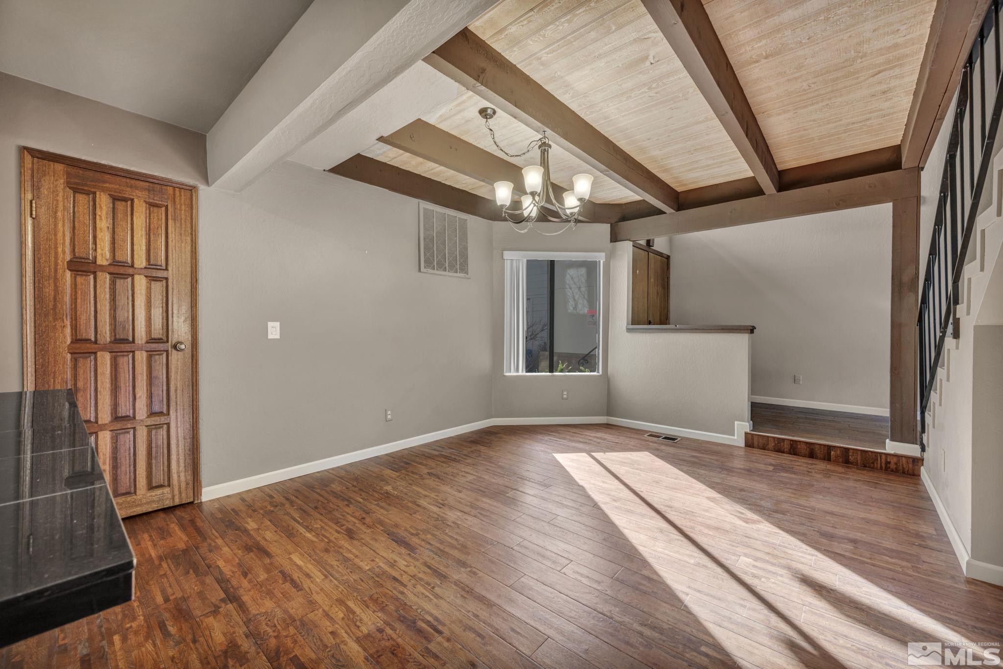 4311 Clyde Court Reno, NV 89509 - Photo 7 of 40 a view of an empty room with wooden floor and a window