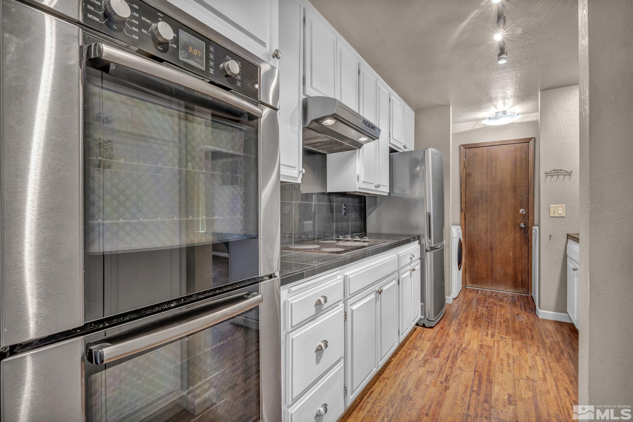 4311 Clyde Court Reno, NV 89509 - Photo 10 of 40 a kitchen with stainless steel appliances granite countertop a stove and a refrigerator