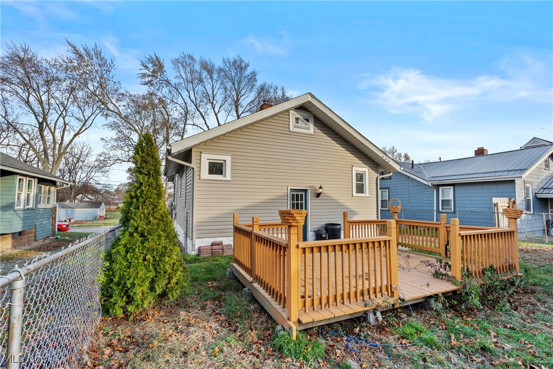 640 Plainfield Road Akron, OH 44312 - Photo 20 of 25 Rear view of house with a chimney and a wooden deck