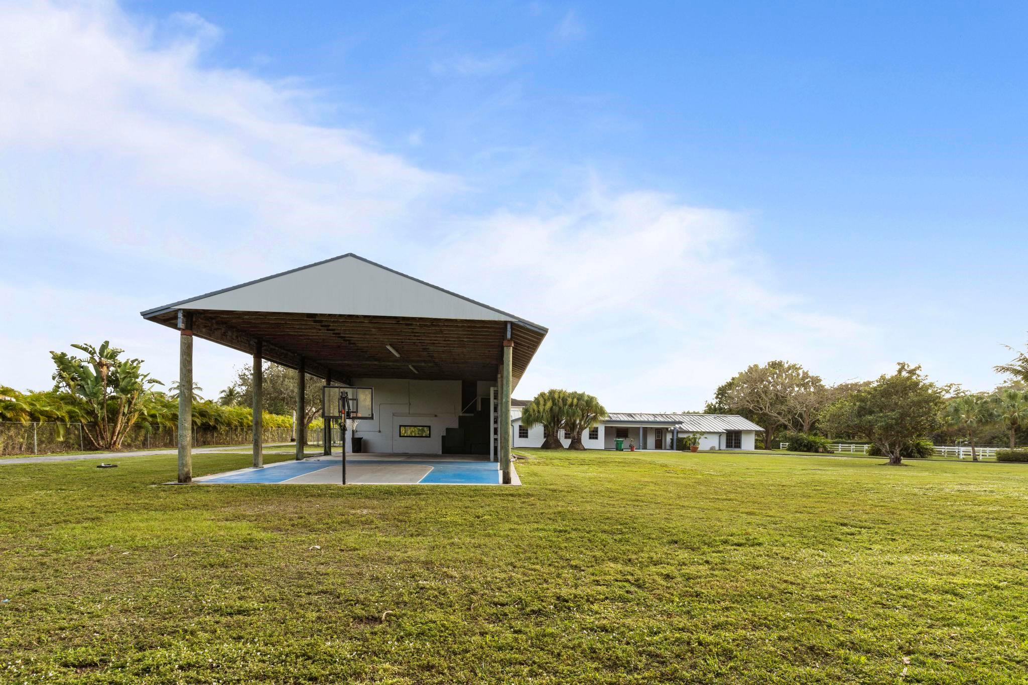 17781 Southwest 52nd Court Southwest Ranches, FL 33331 - Photo 13 of 39 a front view of a house with garden