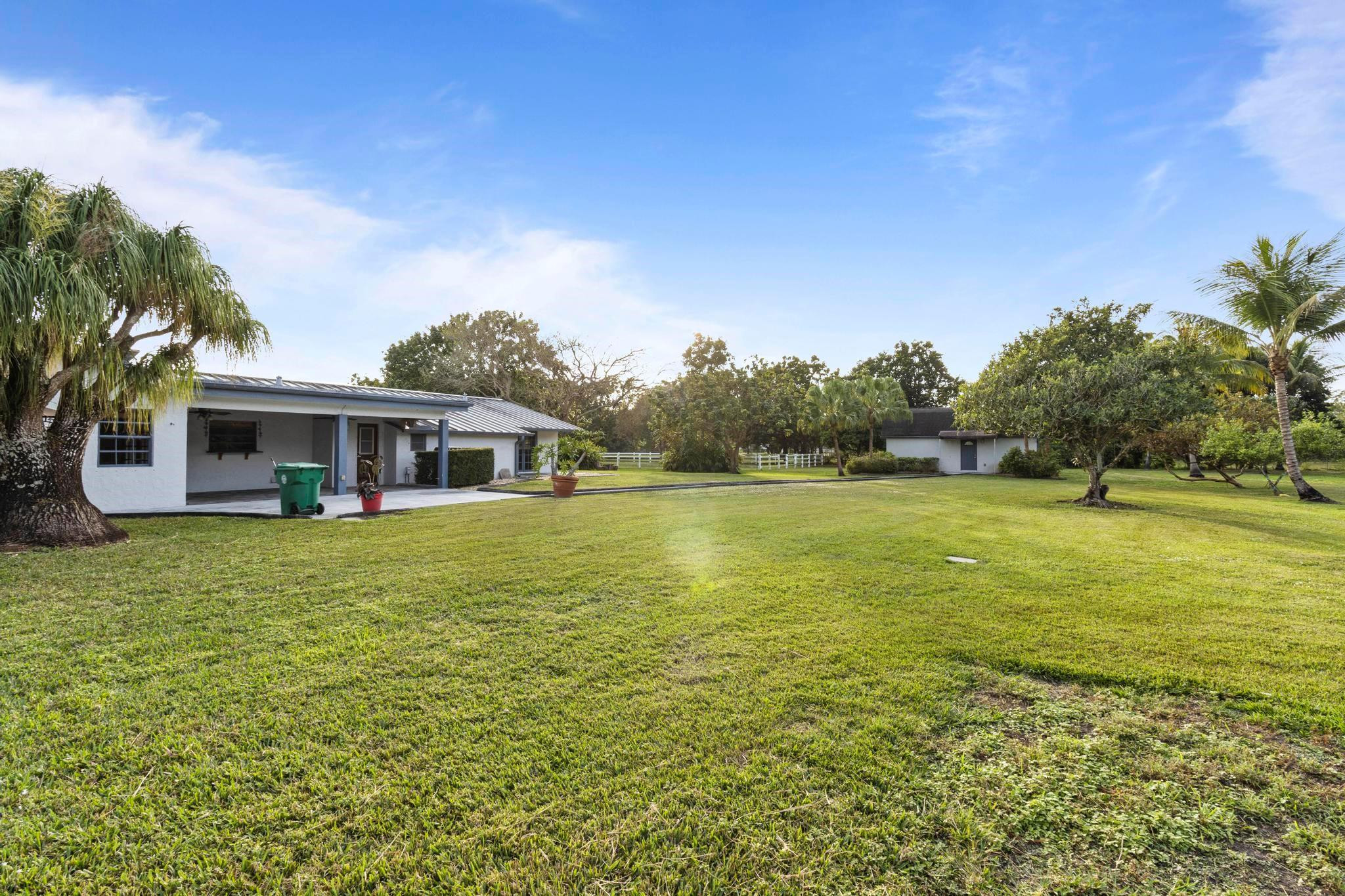 17781 Southwest 52nd Court Southwest Ranches, FL 33331 - Photo 14 of 39 a front view of a house with a garden