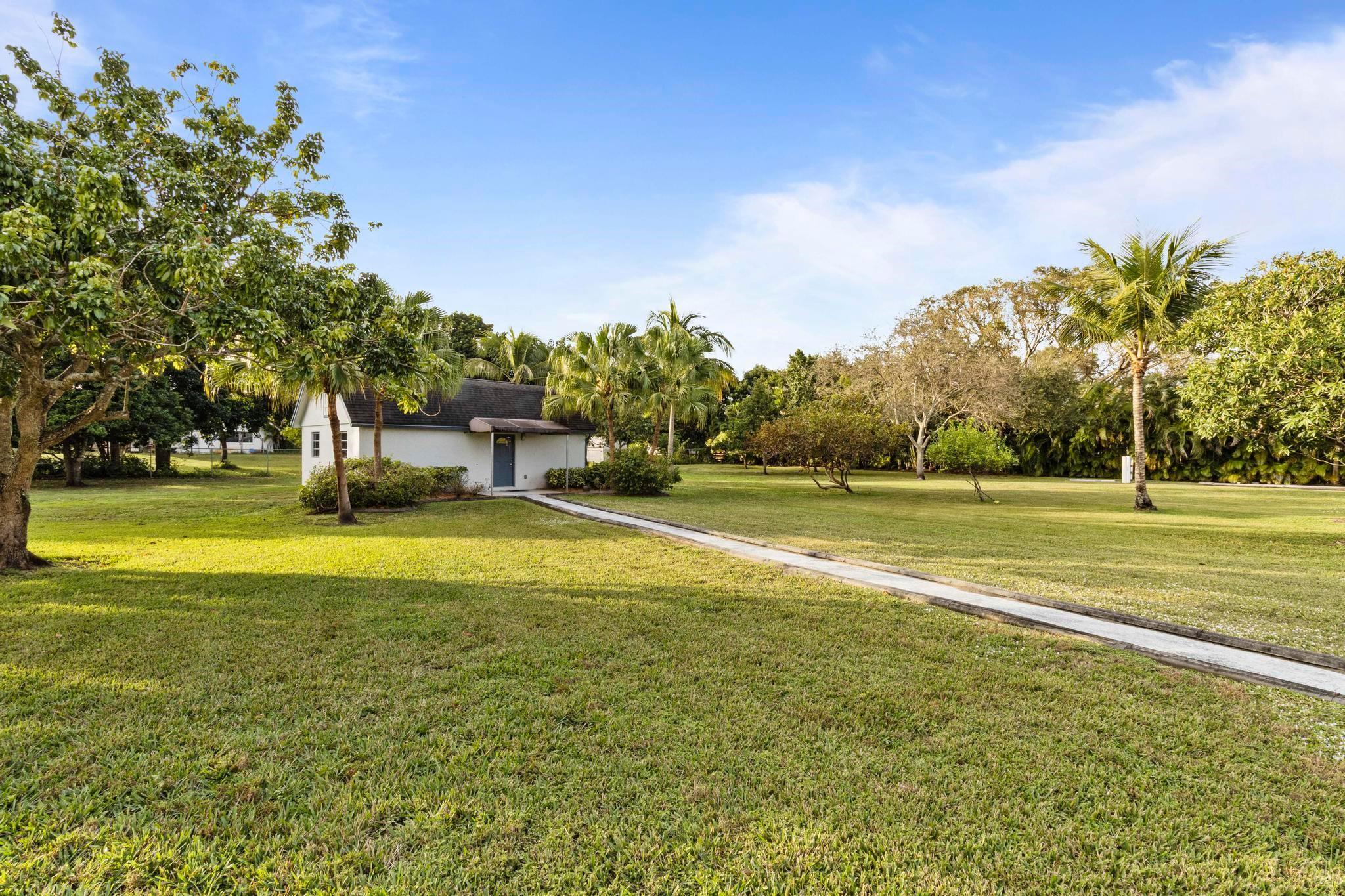 17781 Southwest 52nd Court Southwest Ranches, FL 33331 - Photo 16 of 39 a view of a swimming pool with an outdoor space and seating area