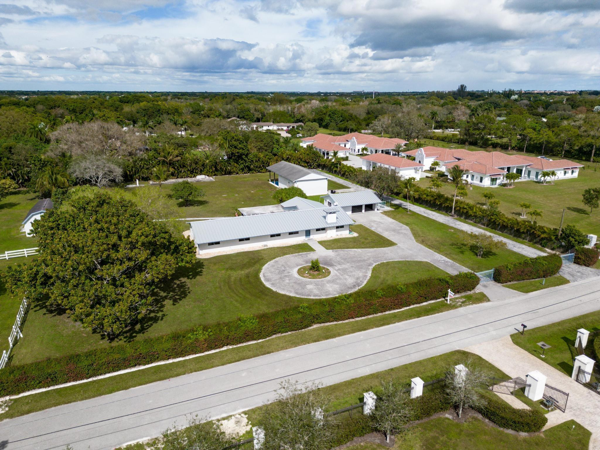 17781 Southwest 52nd Court Southwest Ranches, FL 33331 - Photo 27 of 39 a view of a pool with lawn chairs and couches with wooden floor