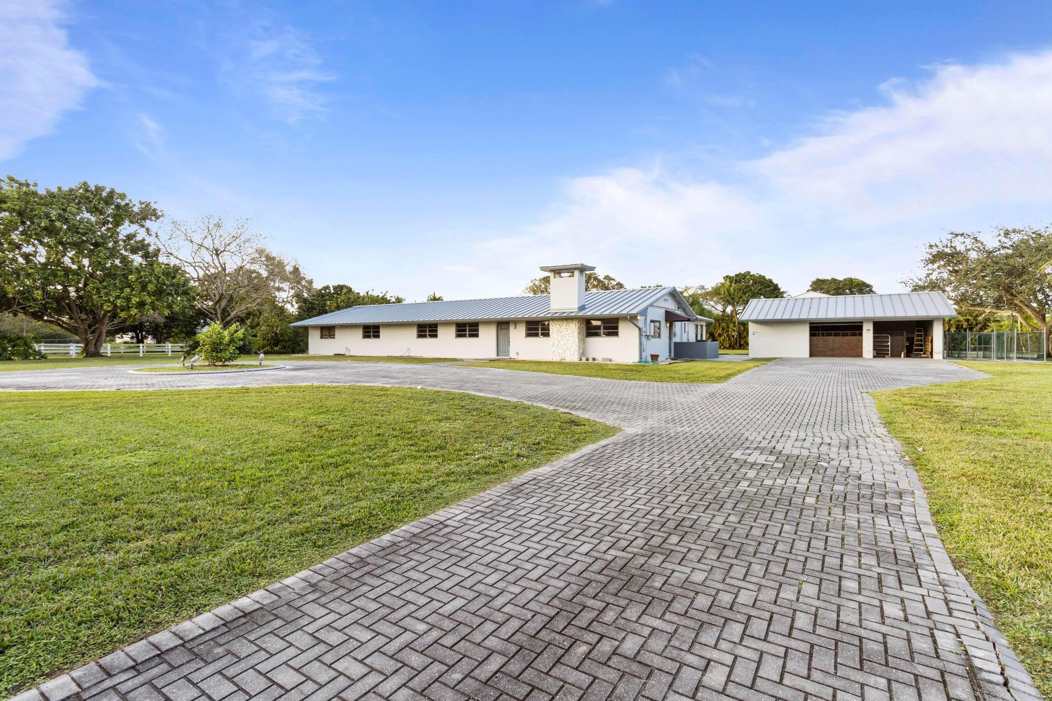 17781 Southwest 52nd Court Southwest Ranches, FL 33331 - Photo 3 of 39 a view of a swimming pool with an outdoor seating and a yard