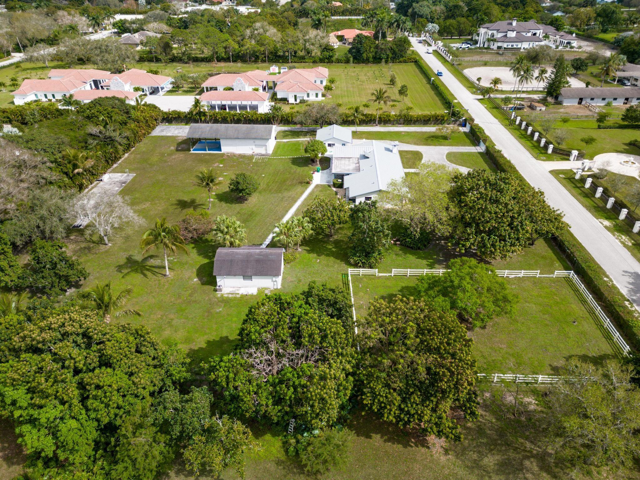 17781 Southwest 52nd Court Southwest Ranches, FL 33331 - Photo 34 of 39 an aerial view of residential houses with outdoor space and swimming pool