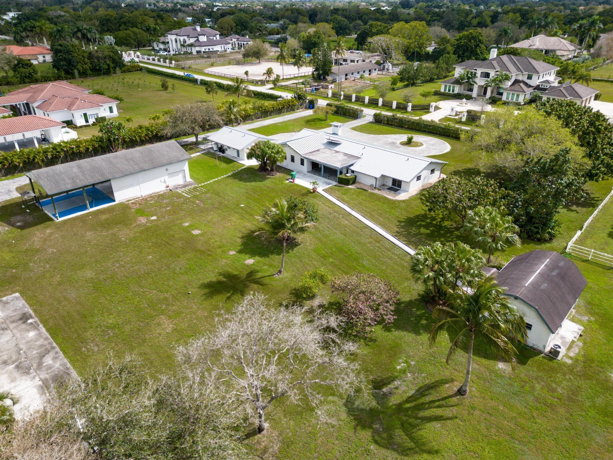 17781 Southwest 52nd Court Southwest Ranches, FL 33331 - Photo 35 of 39 an aerial view of residential houses with outdoor space and swimming pool