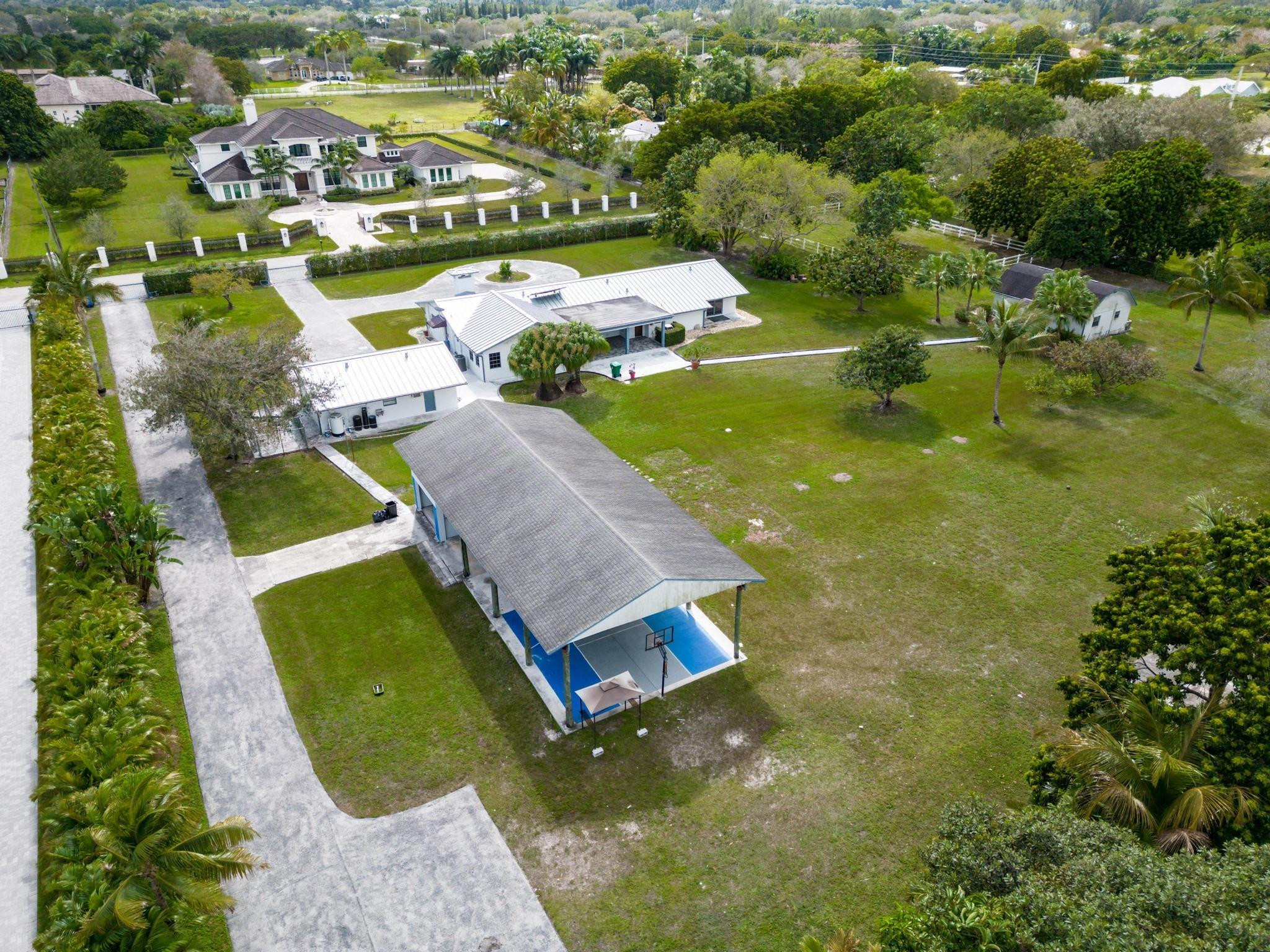 17781 Southwest 52nd Court Southwest Ranches, FL 33331 - Photo 36 of 39 an aerial view of residential houses with outdoor space and swimming pool