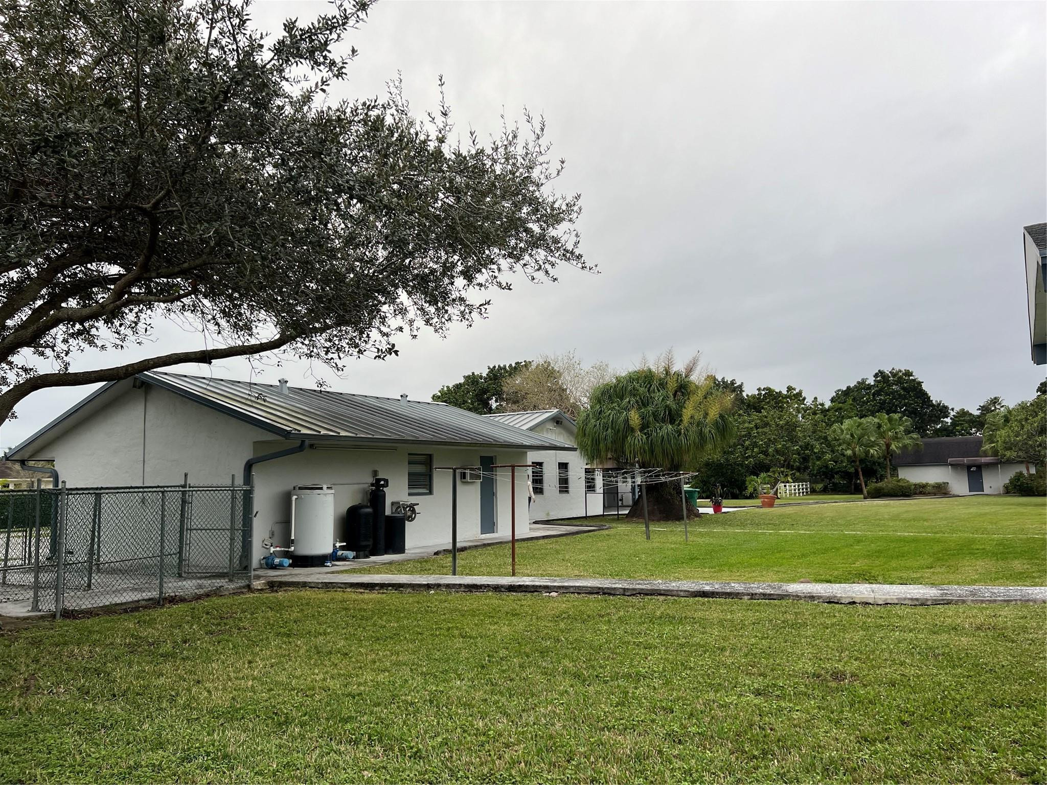 17781 Southwest 52nd Court Southwest Ranches, FL 33331 - Photo 7 of 39 a front view of a house with a garden and trees