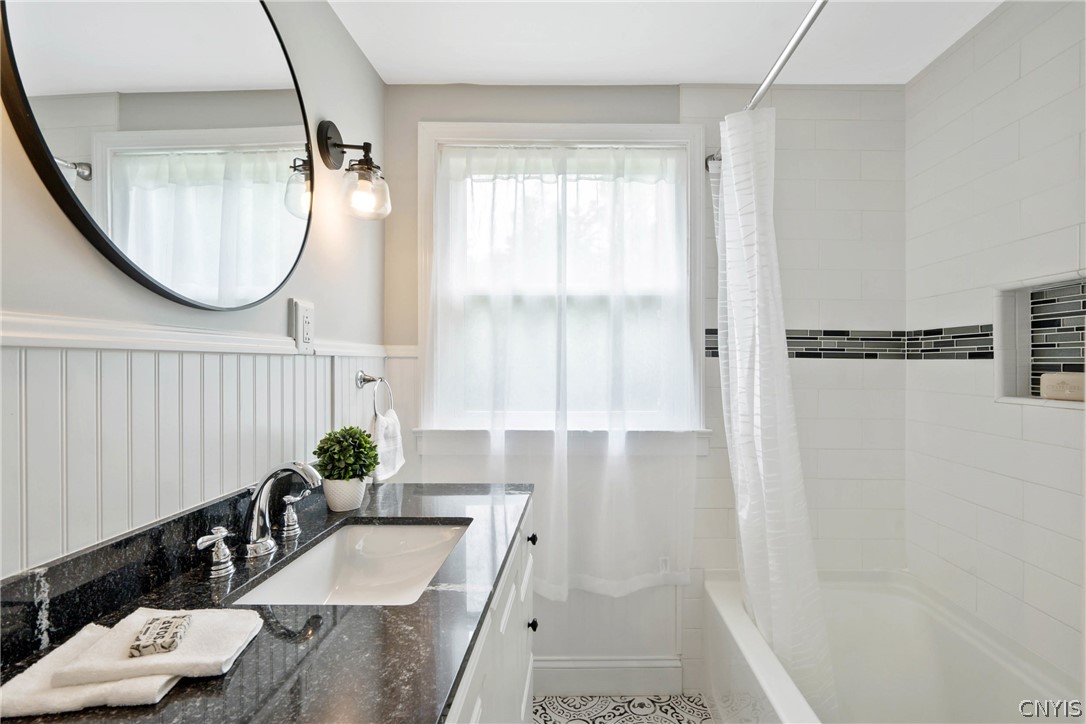 6130 South Bay Road Cicero, NY 13039 - Photo 18 of 30 This breathtaking bathroom boasts a black granite-topped vanity, subway tile shower surround and luxe fixtures - you will feel like you are at the spa in your own home!