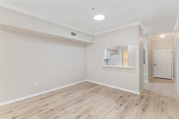 a view of a room with wooden floor and white walls